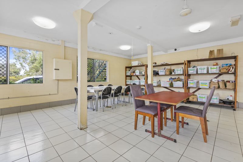 Dining area with tables and food storage shelving